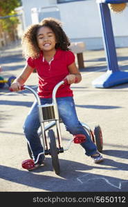 Child Riding Tricycle In Playground