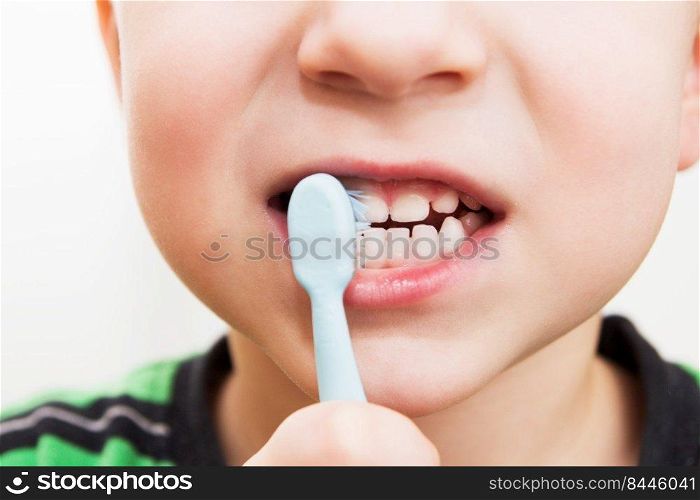 child&rsquo;s teeth with a toothbrush