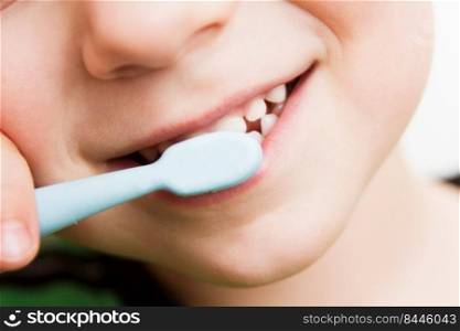 child&rsquo;s teeth with a toothbrush