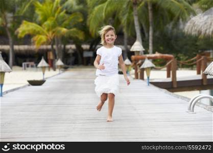 Child Running Along Wooden Jetty