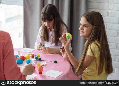 Child shows mom painted easter egg