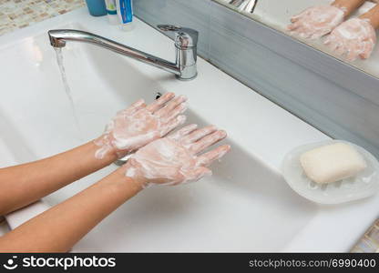 Child shows soaped hands