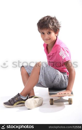 Child sitting on his skateboard