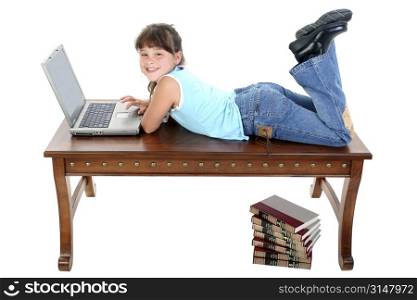 Child Sitting on Table Working On Laptop.
