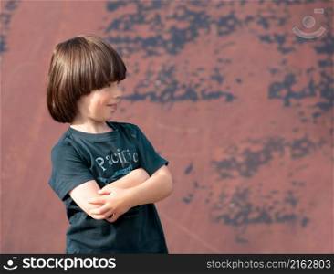 Child smiles and crossed hands on chest, portrait