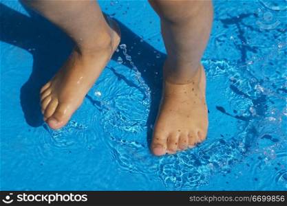 Child Standing In Shallow Pool Water