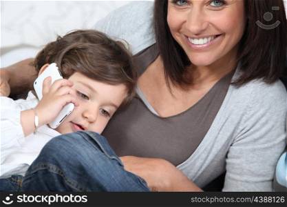 Child using his mother&rsquo;s cellphone