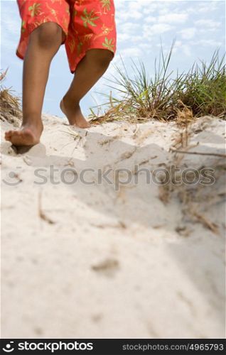 Child walking down dune