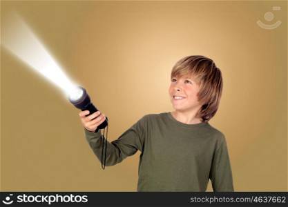 Child with a flashlight looking for something on brown background