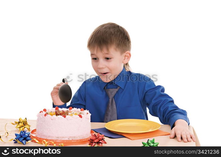 child with a large spoon is going to eat cake isolated on white background