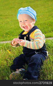 child with dandelion on meadow