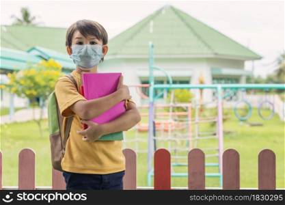 Child with face mask back at school after covid-19 quarantine and lock down.