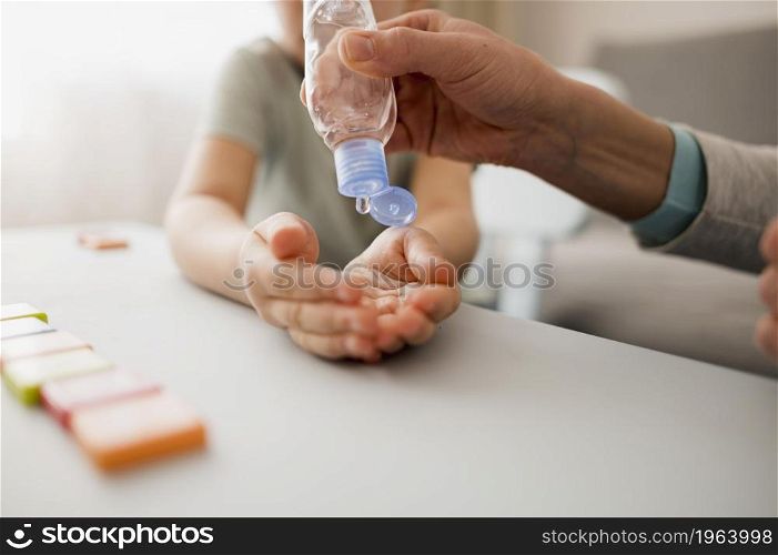 child with hand sanitizer home before class. High resolution photo. child with hand sanitizer home before class. High quality photo