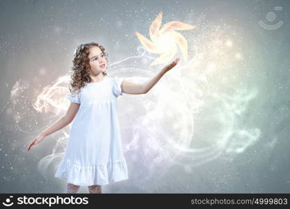 Child with magic light. Little girl with magic lights and shining around