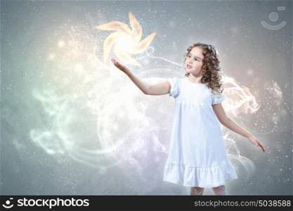 Child with magic light. Little girl with magic lights and shining around