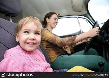child with mother in car
