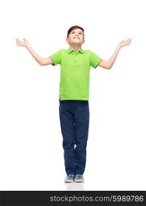childhood, achievement, gladness and people concept - happy smiling boy in green polo t-shirt raising hands and looking up
