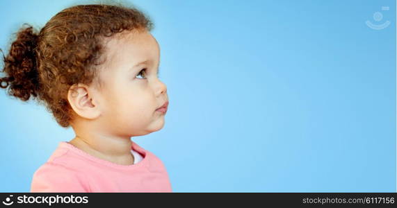 childhood, advertisement and people concept - beautiful african american little baby girl portrait over blue background