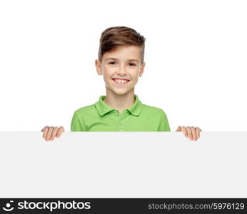 childhood, advertisement and people concept - happy smiling boy in green polo t-shirt holding white blank board