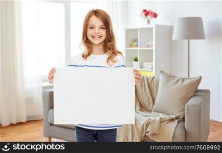 childhood, advertisement and people concept - happy smiling girl holding white blank paper sheet at home. happy girl holding white blank paper sheet at home