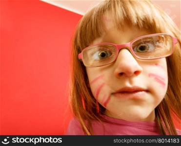 Childhood and development concept. Little girl schoolchild in glasses with the body painted as e cat, funny face. Wide angle view