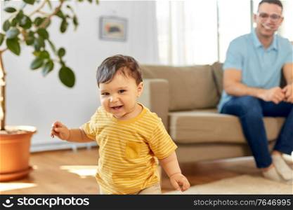 childhood and family concept - happy baby boy with father at home. happy baby boy with father at home