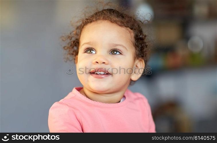 childhood and people concept - beautiful little mulatto baby girl face. beautiful little mulatto baby girl face