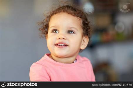 childhood and people concept - beautiful little mulatto baby girl face. beautiful little mulatto baby girl face
