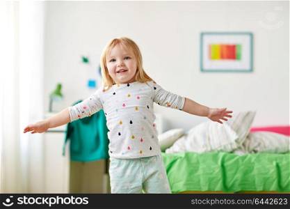 childhood and people concept - happy little girl having fun at home. happy little girl having fun at home