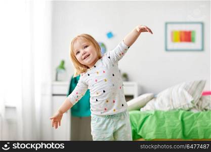 childhood and people concept - happy little girl having fun at home. happy little girl having fun at home. happy little girl having fun at home