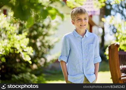 childhood and people concept - happy smiling boy at summer garden. happy smiling boy at summer garden