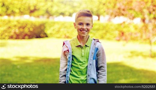 childhood and people concept - happy smiling boy at summer park. happy smiling boy at summer park