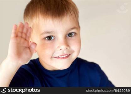 childhood and people concept - portrait of happy smiling little boy waving hand. portrait of happy smiling little boy waving hand