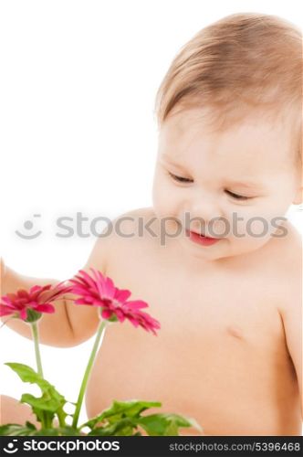 childhood and toys concept - cute little boy playing with flower