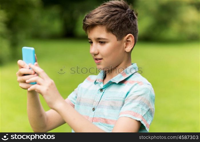 childhood, augmented reality, technology and people concept - boy with smartphone playing game in summer park