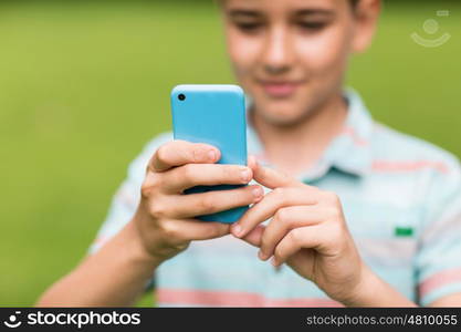 childhood, augmented reality, technology and people concept - boy with smartphone playing game outdoors at summer. boy with smartphone outdoors at summer