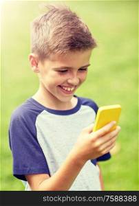 childhood, augmented reality, technology and people concept - happy smiling boy with smartphone playing game in summer park. boy with smartphone playing game in summer park