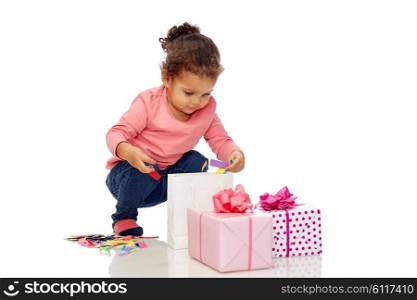 childhood, birthday, party, holidays and people concept - happy little african american baby girl with gift boxes playing with confetti and shopping bag