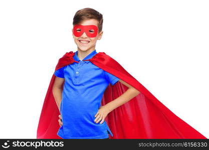 childhood, carnival costume and people concept - happy boy in red superhero cape and mask