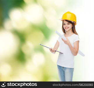 childhood, construction, architecture, building and people concept - smiling little girl in protective helmet with clipboard and blueprint