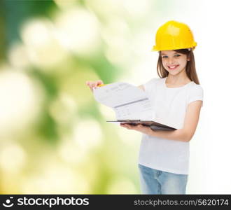 childhood, construction, architecture, building and people concept - smiling little girl in protective helmet with clipboard turning page