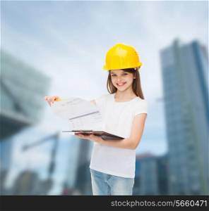 childhood, construction, architecture, building and people concept - smiling little girl in protective helmet with clipboard turning page
