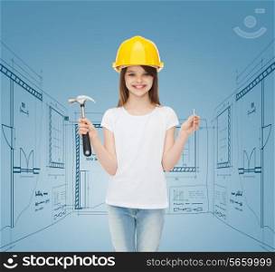 childhood, construction, architecture, building and people concept - smiling little girl in protective helmet with hammer
