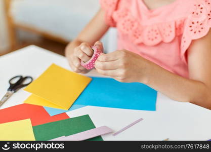 childhood, creativity and hobby concept - close up of creative girl with adhesive tape making greeting card at home. creative girl making greeting card at home