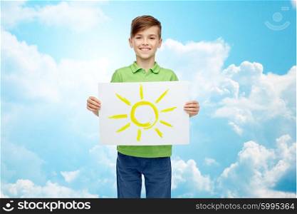 childhood, creativity, art and people concept - happy smiling boy holding drawing or picture of sun over blue sky and clouds background
