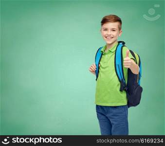 childhood, education and people concept - happy smiling student boy with school bag over green school chalk board background