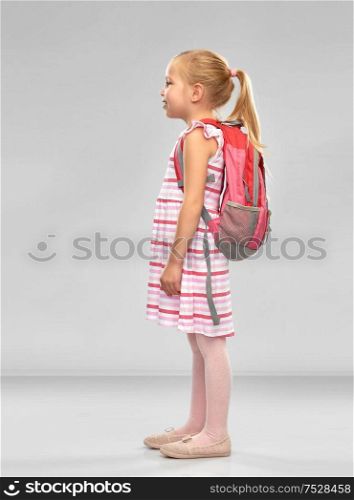 childhood, education and people concept - happy student girl with school bag over grey background. happy student girl with school bag
