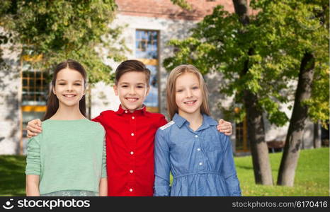 childhood, education, friendship and people concept - happy smiling children hugging over summer campus background