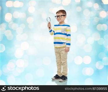 childhood, education, investigation, discovery and people concept - happy little boy in eyeglasses with magnifying glass over blue holidays lights background