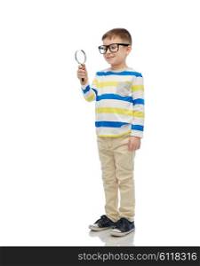 childhood, education, investigation, discovery and people concept - happy little boy in eyeglasses with magnifying glass
